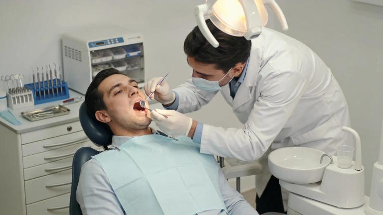 Dentist examining a patient in a dental office during a root canal treatment