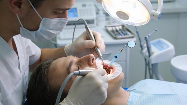 General dentist performing root canal treatment, emphasizing dental care and patient comfort in a clinical setting