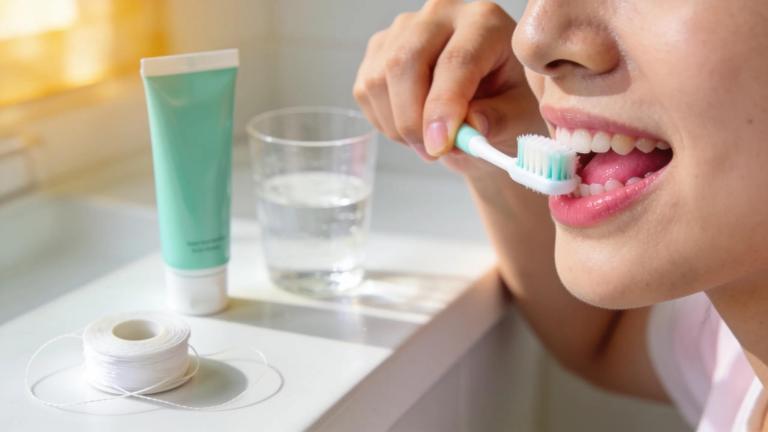 Bright dental care scene with a person brushing teeth, emphasizing gum health and hygiene