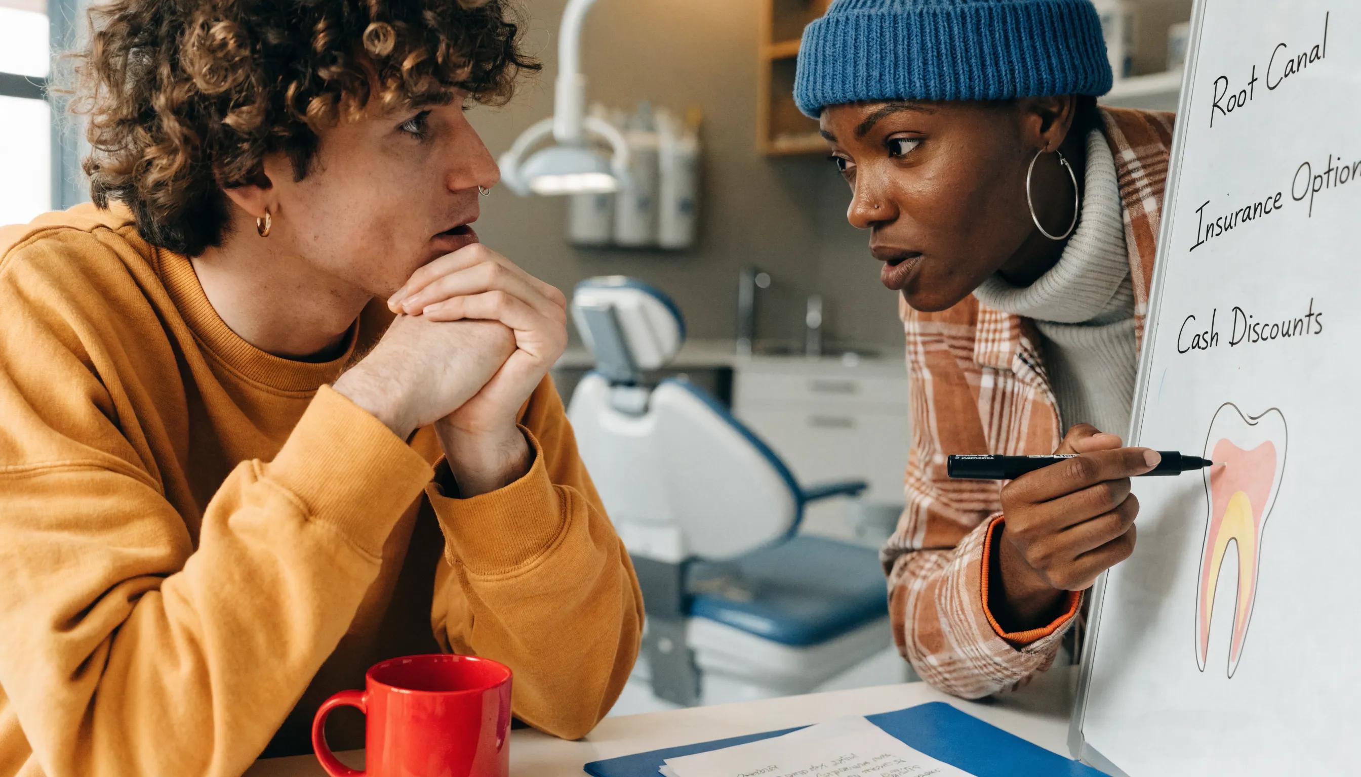 Patient consulting with a dentist about root canal options, showcasing cost-saving strategies in dental treatments